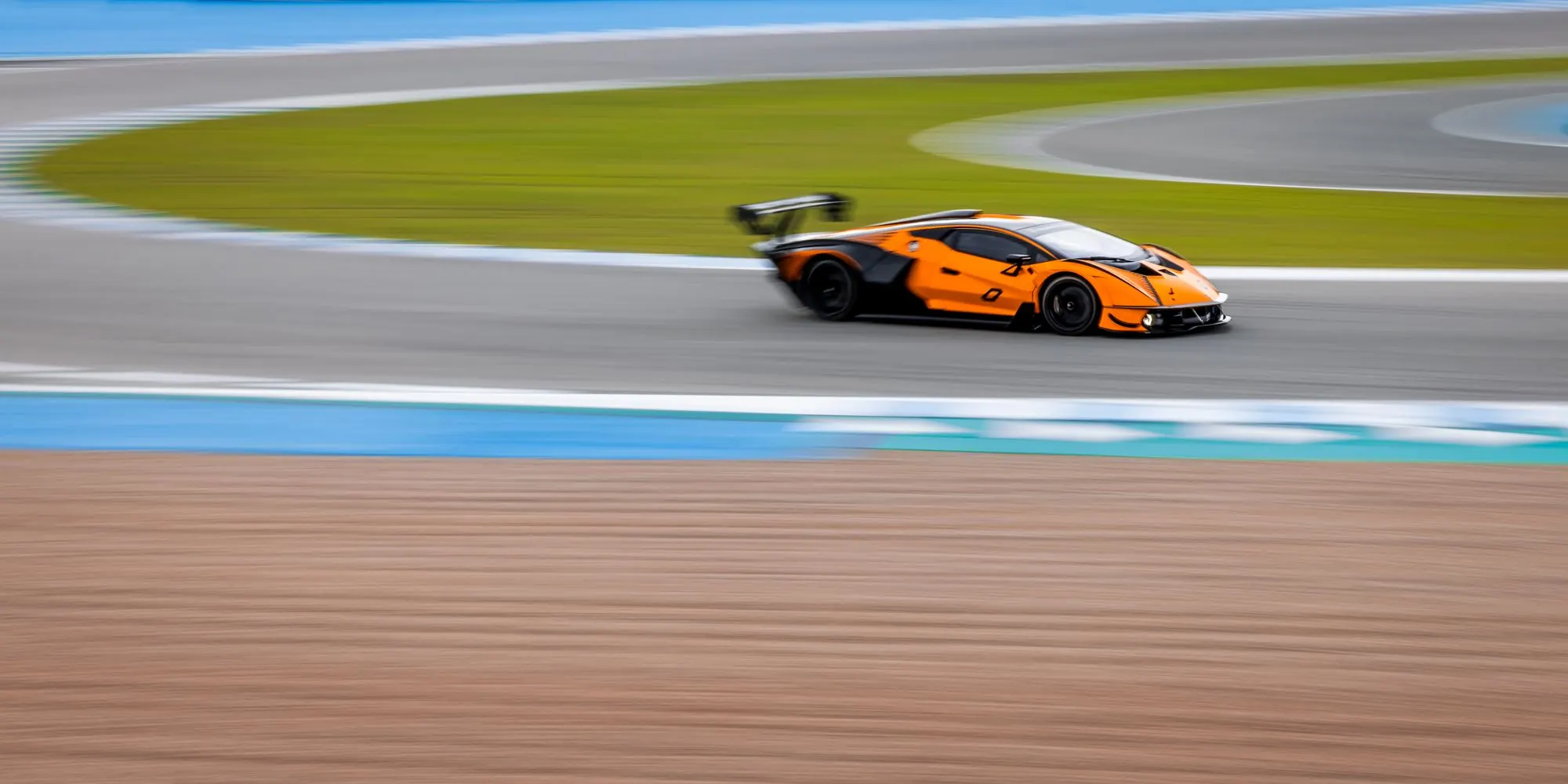 Orange sports car on a race track